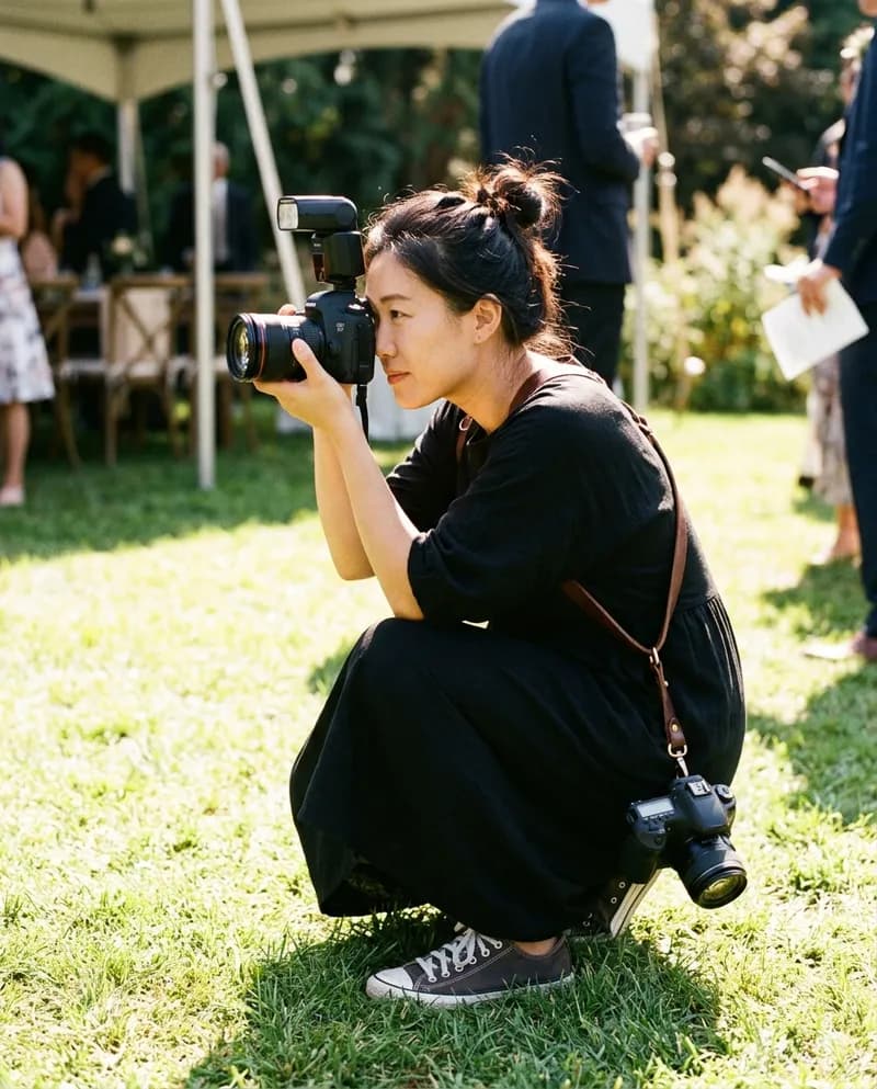 A wedding photographer crouched, shooting